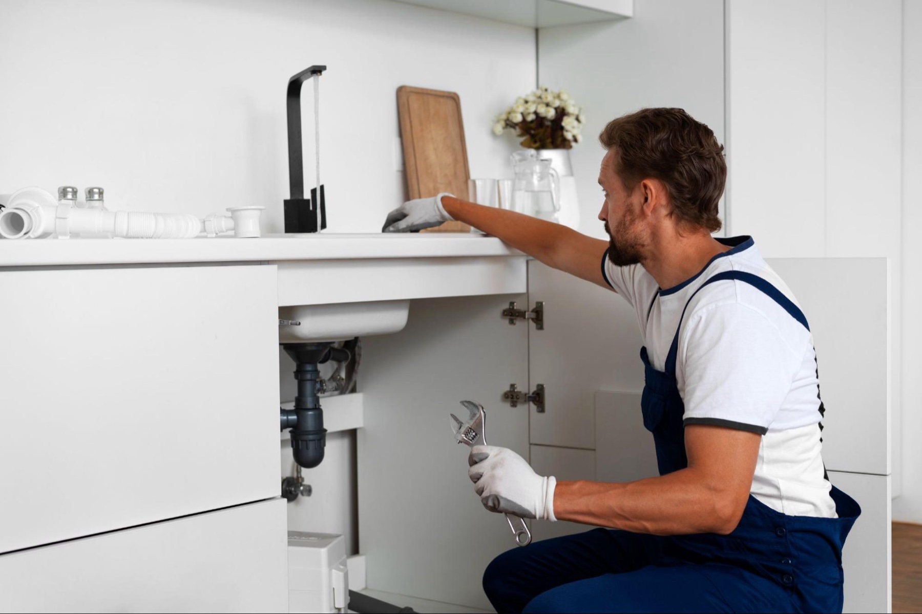 Plumber fitting an under-sink water treatment system